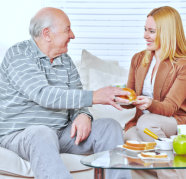 elderly man and caregiver smiling