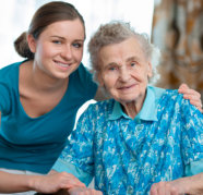 caregiver and elderly woman smiling