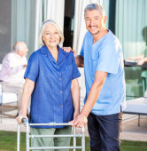 caregiver assisting an elderly woman