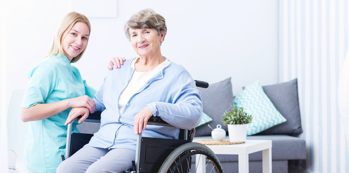 caregiver and elderly woman smiling