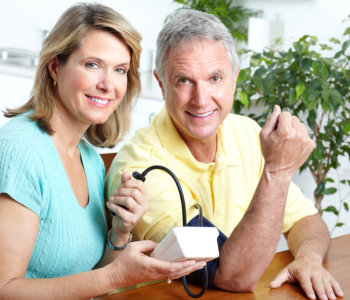 caregiver checking blood pressure